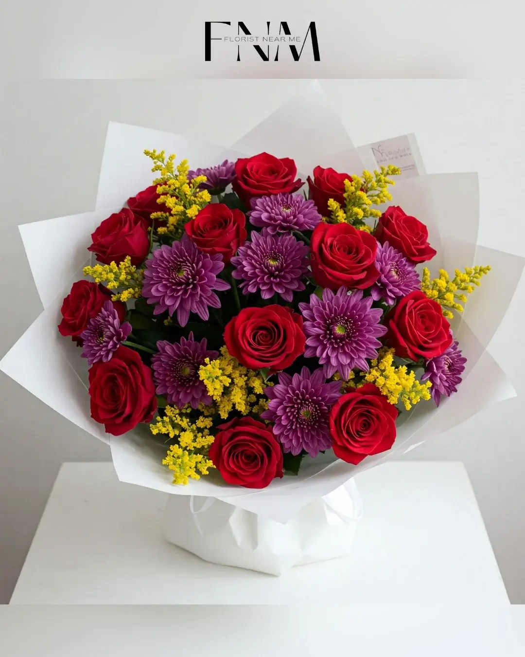 Bouquet of red roses with purple chrysanthemums